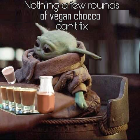 This meme is a humorous image featuring the character Baby Yoda from the Star Wars franchise, sitting at a table with a cup of coffee and a plate of cookies. The text "Nothing a few rounds of vegan choco can't fix" is written above the image, implying that even the most challenging situations can be solved with a simple cup of coffee and a sweet treat.